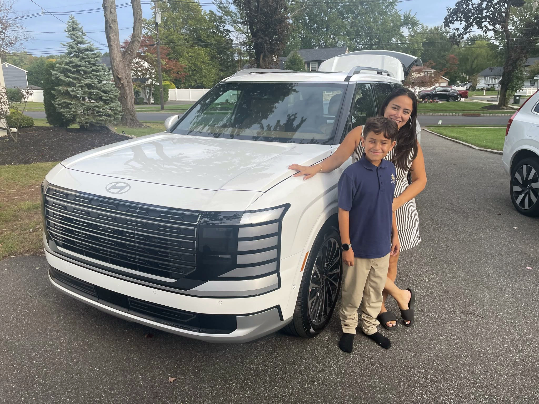 White Hyundai SUV with an adult and child